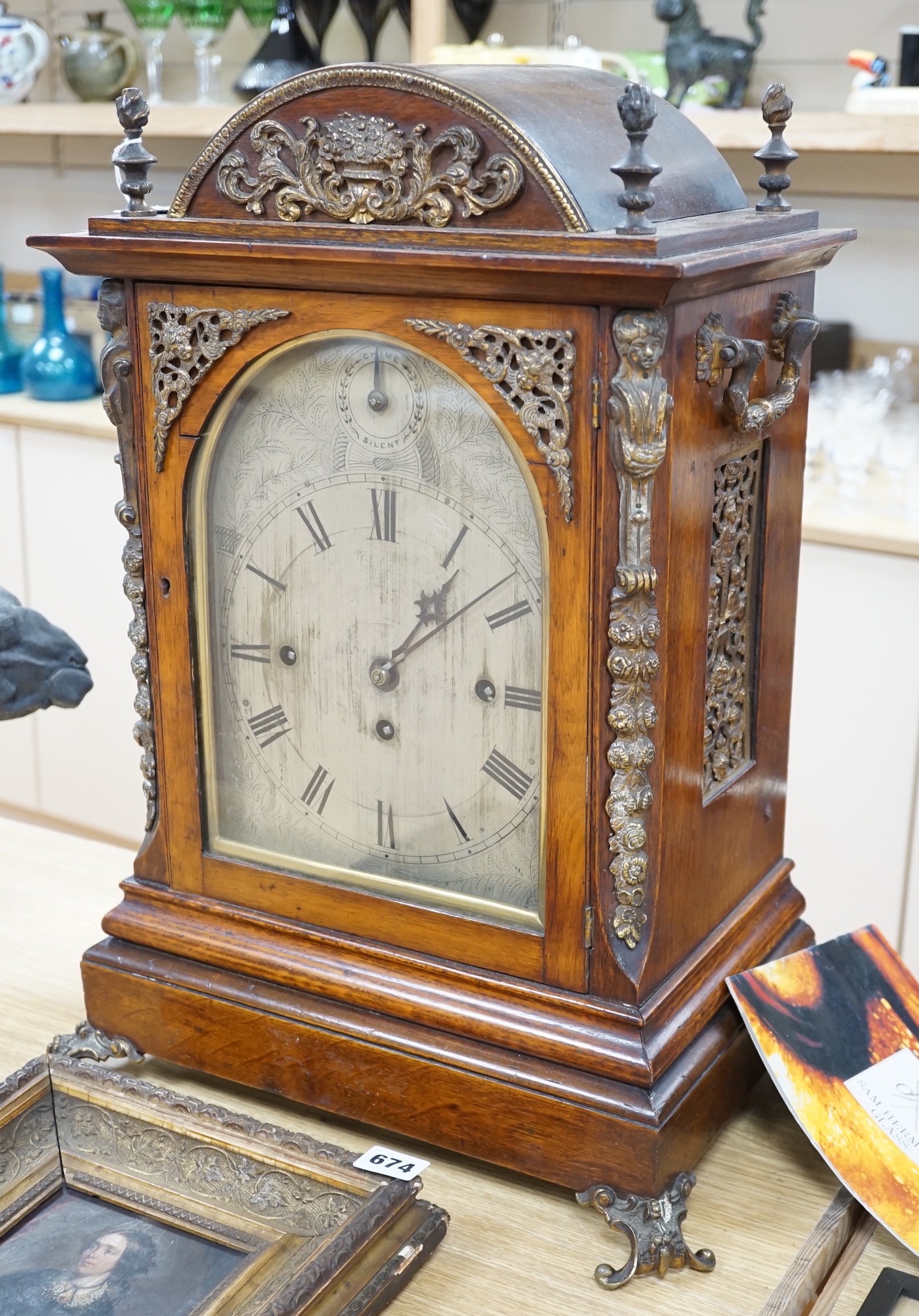 A late Victorian oak bracket clock with brass mounts and chiming movement, 55cms high